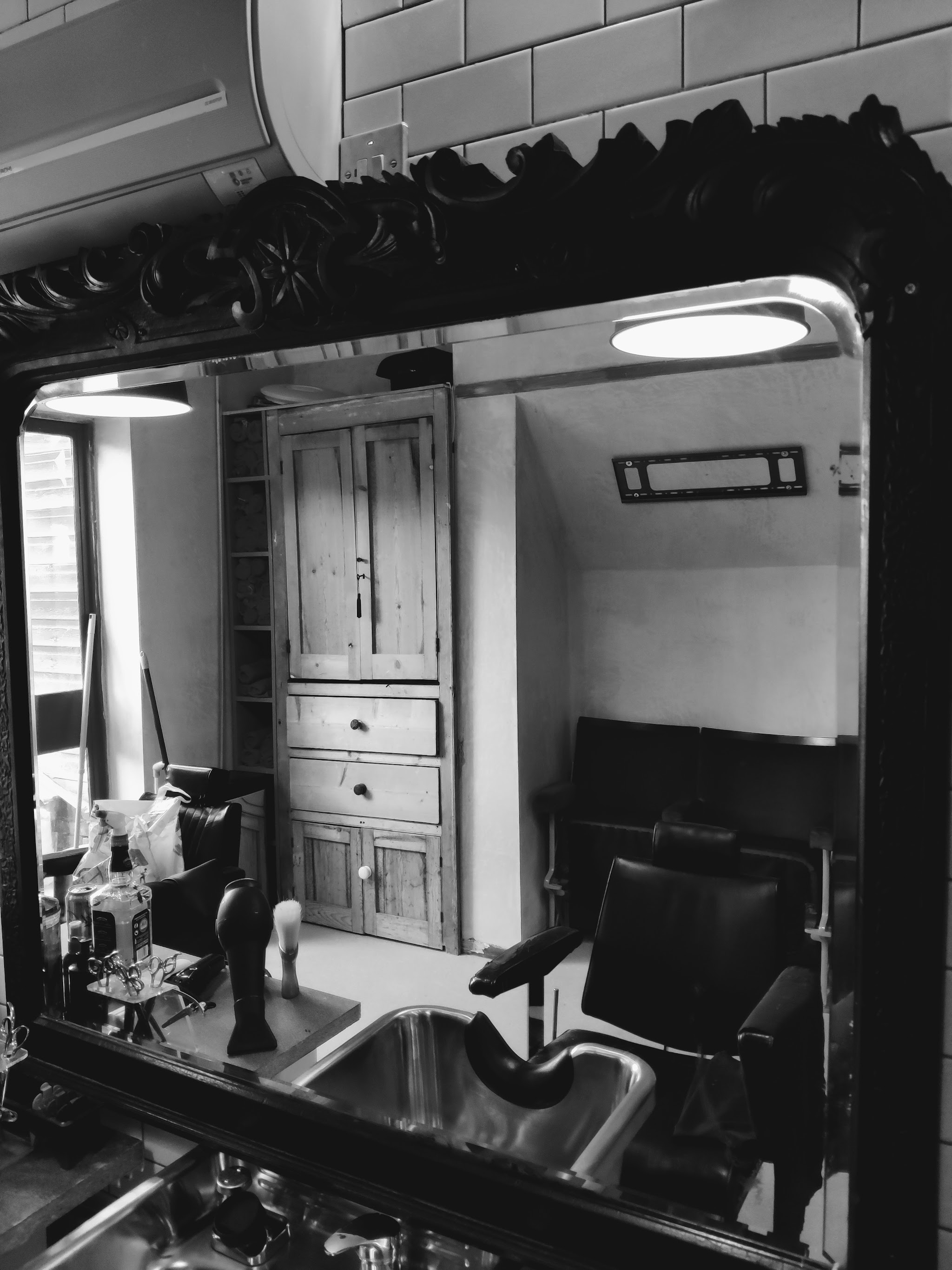 Black and white view of the shop reflected in an ornate mirror