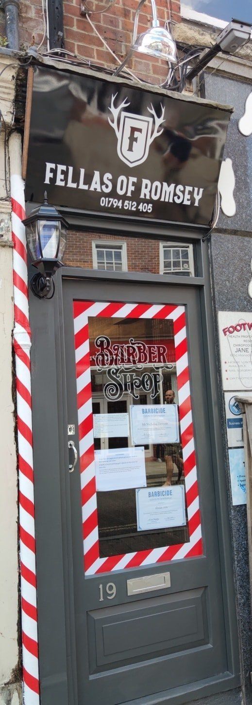 The Fellas of Romsey shopfront at No. 19 with its red and white striped door frame